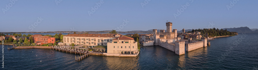 Panoramic aerial view of Scaliger Castle at sunrise in Sirmione, Lake Garda in Italy.