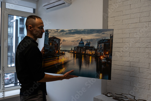 Photo canvas print. A man holding a photography with gallery wrap photo