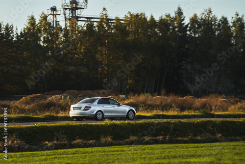 Five-door premium luxury car speeding on the evening highway Sophisticated expensive car on the road. Premium and Elegant luxurious car on the evening road