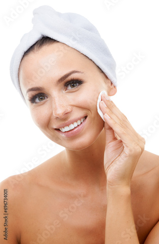 Beauty, portrait or happy woman in studio with cotton pad on face, towel or makeup cleaning product. Dermatology, remove or skincare for model with smile, toner or facial glow on white background