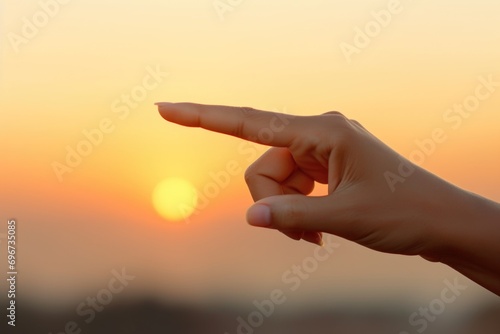 A person pointing towards the sun. Suitable for illustrations, educational materials, or presentations