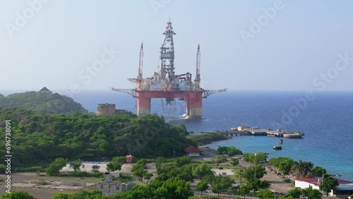 Orbit around off shore oil rig on coastal waters of Caribbean photo