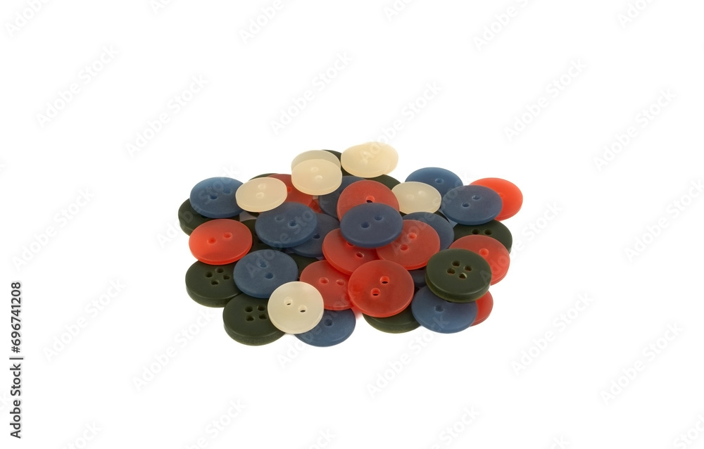 A handful of different plastic buttons on a white background A handful of different plastic buttons on a white background