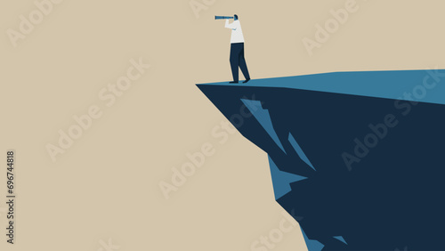 A man on a cliff looks into the distance through a telescope.