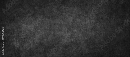 Close up of dark graphite or concrete surface texture, dark black grunge textured blackboard or chalkboard, monochrome slate grunge concrete wall or plaster, distressed overlay concrete texture.