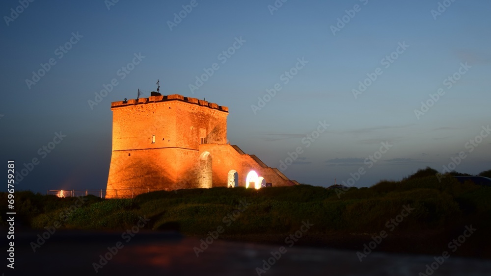 Ancient watchtower on the Italian coast at night