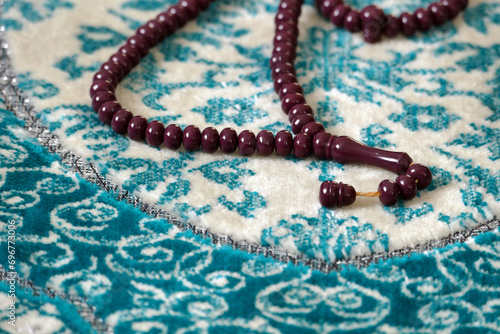 Close-up of the rosary sitting on the prayer rug,