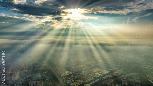 Aerial view of Saigon cityscape at morning with misty sun rays sky in Southern Vietnam. Urban development texture  transport infrastructure and green parks