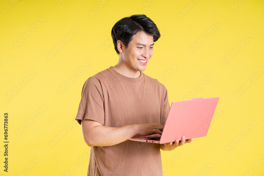 Portrait of asian man posing on yellow background Portrait of asian man posing on yellow background
