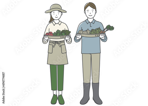 籠いっぱいの野菜を持つ若い男性と女性