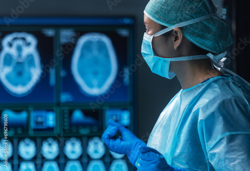 фотографія Team of medical doctors performs surgical operation in modern operating room using high-tech technology