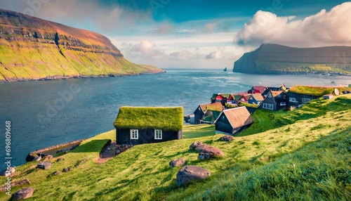 panoramic summer view of kirkjubour village with turf top houses faroe islands denmark europe wonderful morning scene of hestur island traveling concept background photo