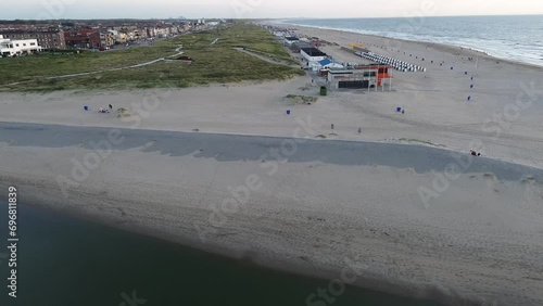 Netherlands. Beautiful flight in summer over the beach in Katwijk aan Zee. People are resting near the sea. Houses for tourists. Beautiful sunset over the North Sea. photo