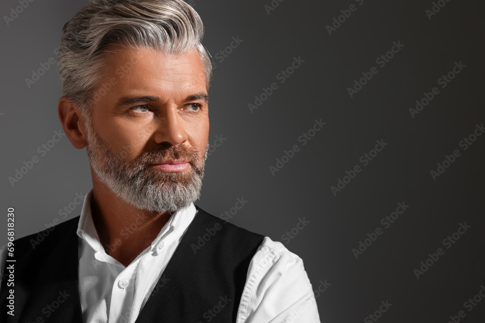 Portrait of confident man with beautiful hairstyle on dark background. Space for text Portrait of confident man with beautiful hairstyle on dark background. Space for text