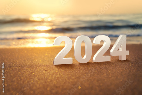 Year 2024 numbers placed on the beach. Start the new year on the beach in the morning and get ready to celebrate with a party with friends and family.