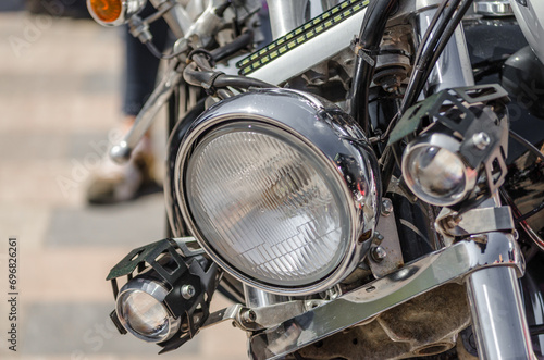 chrome shiny chopper motorcycle headlight close up