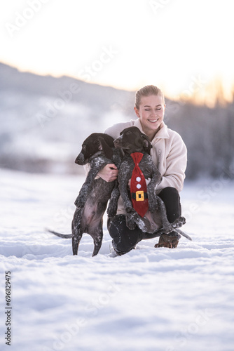 Christmas Joy: Girl and Puppies Frolicking in the Snow