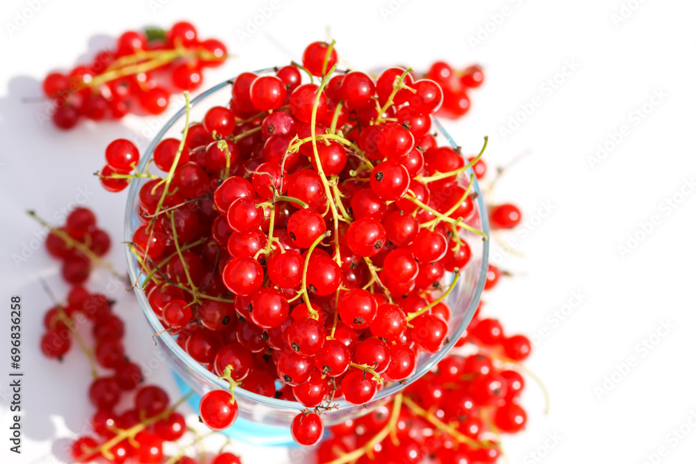 Ripe red currant berries in a transparent cup. Healthy food ingredients. Ripe red currant berries in a transparent cup. Healthy food ingredients.