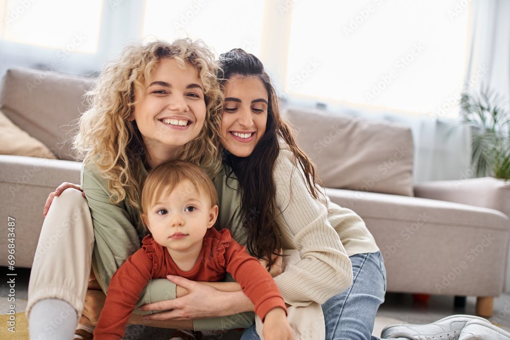 attractive jolly lgbt couple having great time together with their daughter at home, family concept attractive jolly lgbt couple having great time together with their daughter at home, family concept