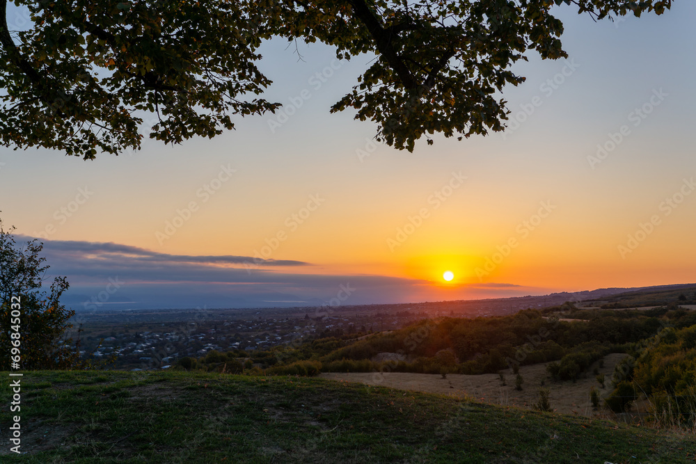 sunrise in a valley with a tree in the foreground sunrise in a valley with a tree in the foreground