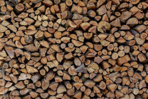 Background with ends of stacked firewood
