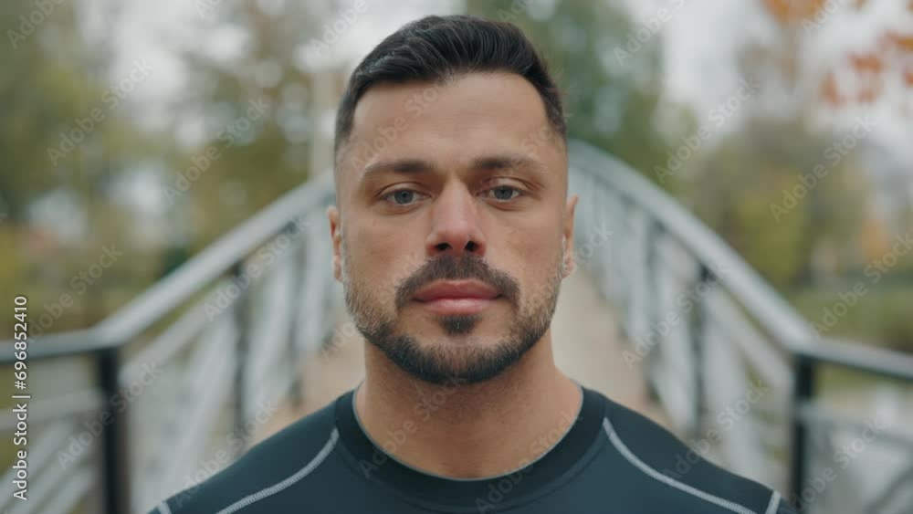 Portrait of the Caucasian Mature Runner Resting After the Outside Training. Handsome Man After Jogging, the Guy Athlete Is Looking at the Camera Outside. People and Sport Concept Portrait of the Caucasian Mature Runner Resting After the Outside Training. Handsome Man After Jogging, the Guy Athlete Is Looking at the Camera Outside. People and Sport Concept