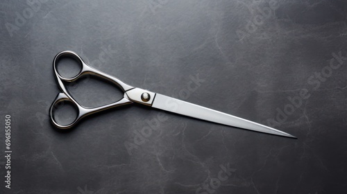 Tailoring scissors on a rough black concrete background. copy space