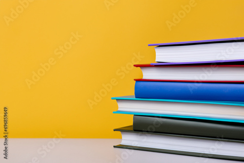 stack of colorful books. textbooks stacked on top of each other, color background. education concept
