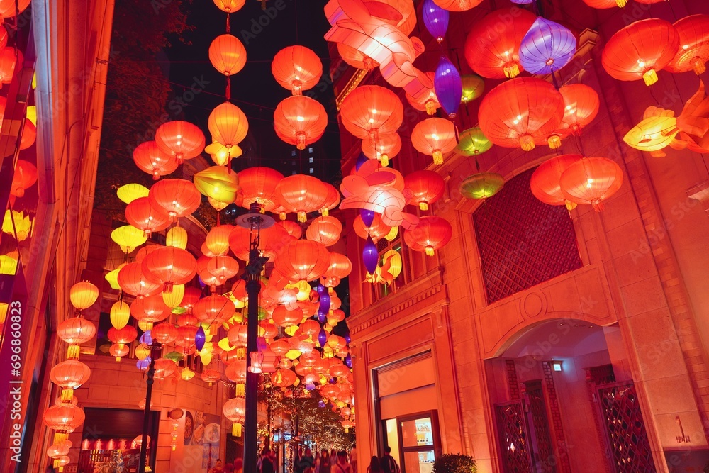 Fototapeta premium Hong Kong street decorated with red lanterns for celebrate the Chinese New Year and crowded street in the center of Hong Kong. Decoration for chinese new year in Hong Kong. Lunar holiday concept. 