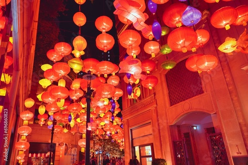 Hong Kong street decorated with red lanterns for celebrate the Chinese New Year and crowded street in the center of Hong Kong. Decoration for chinese new year in Hong Kong.  Lunar holiday concept. 
