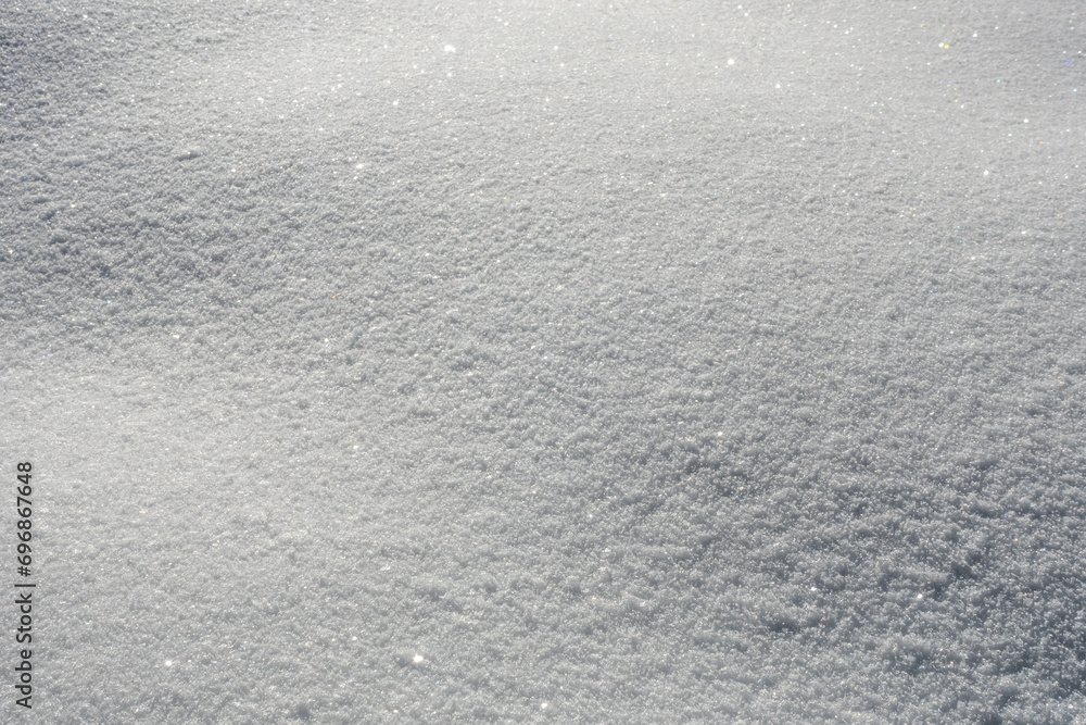 Glittering snow surface in sunlight with sparkling ice crystals Glittering snow surface in sunlight with sparkling ice crystals