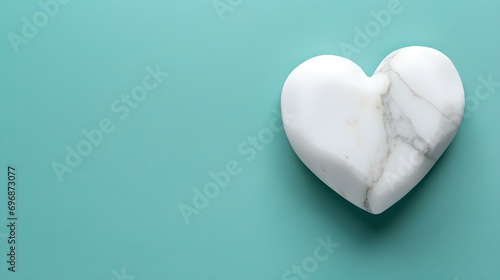 Top View of a White Stone Heart on a turquoise Background. Romantic Template with Copy Space