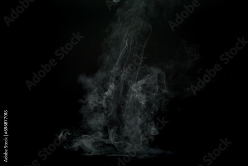 Abstract smoke misty fog on isolated black background. Texture overlays. Design element.