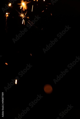 Perfect fire particles embers sparks on black background . Texture overlays.