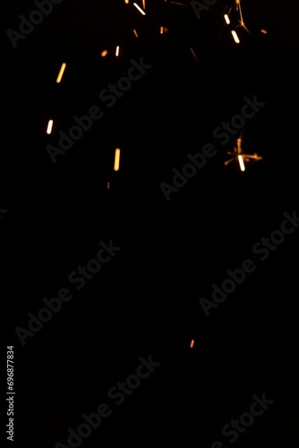 Perfect fire particles embers sparks on black background . Texture overlays.