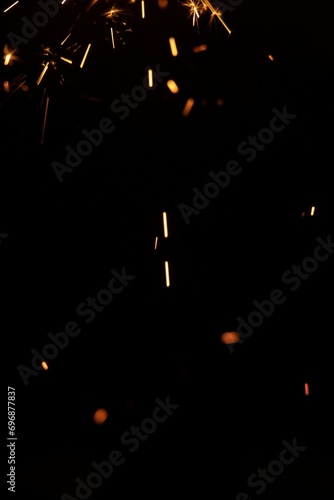 Perfect fire particles embers sparks on black background . Texture overlays.