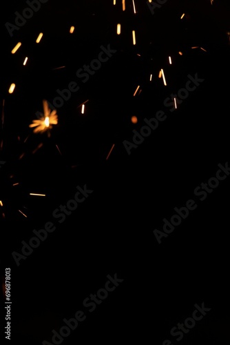 Perfect fire particles embers sparks on black background . Texture overlays.