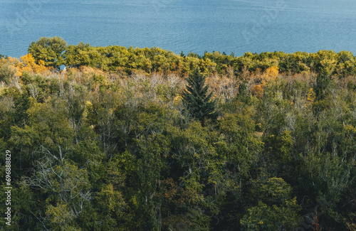 amazing  top view of blue sevan lake in armenia with autumn trees below and vegetation photo