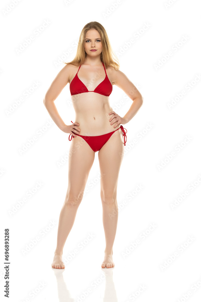 Full body, front view young blond woman in bikini posing on white background Full body, front view young blond woman in bikini posing on white background