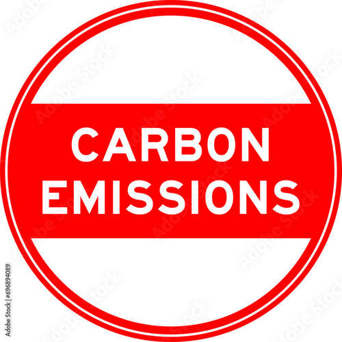 Red color round seal sticker in word carbon emissions on white background