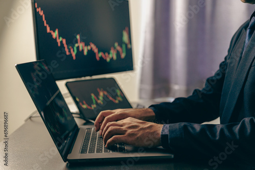 A close-up image of a businessman looking at the direction of the moving average. stock price movement Trading stocks up and down On the laptop computer display screen, finance concept