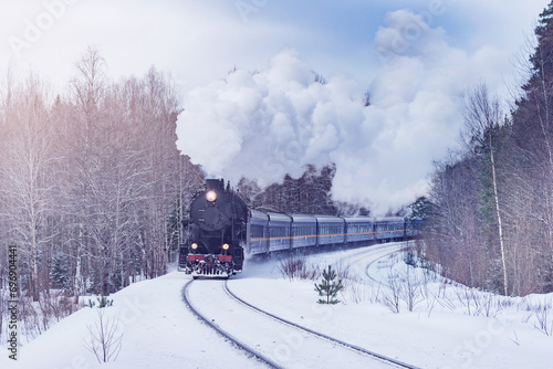 Retro christmas steam train moves through the forest.