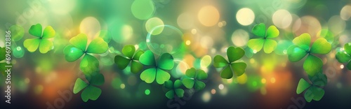 Abstract decorative festive green background with a bokeh effect with three-leaf and four-leaf clover for St. Patrick's Day.