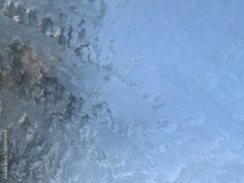 Ice sheet forming an abstract figure of whites and grays.