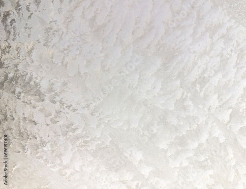 Ice sheet forming an abstract figure of whites and grays.