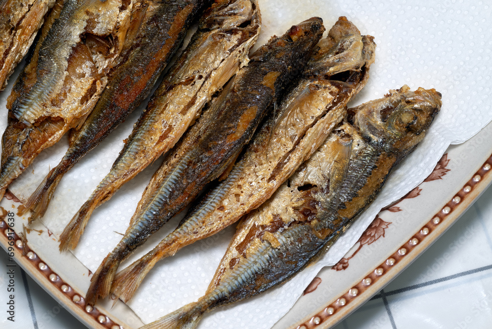 Fried horse mackerel or Japanese jack mackerel on a plate with paper towel Fried horse mackerel or Japanese jack mackerel on a plate with paper towel