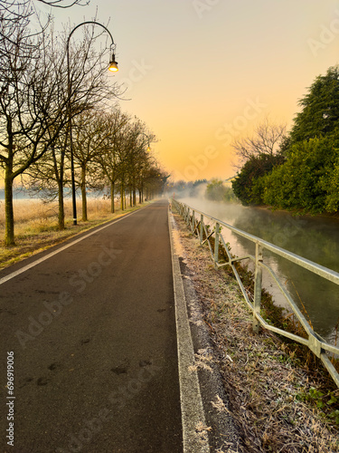 Cycle path along the Naviglio in Milan at dawn.