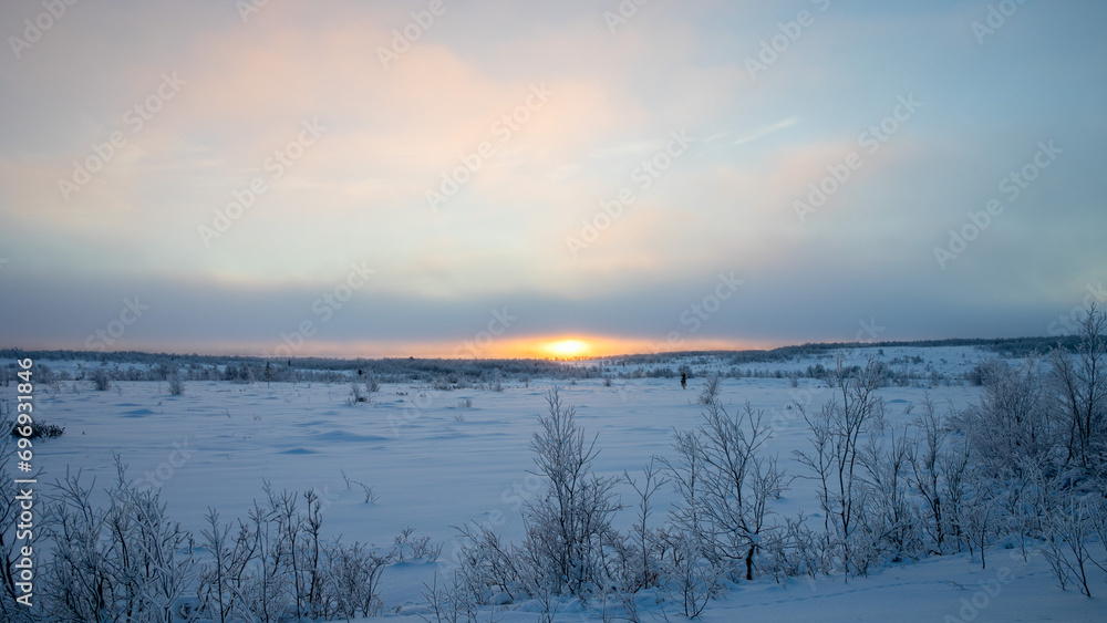 A tranquil winter sunrise over a snow-covered landscape with bare trees, depicting the serenity of a winter morning A tranquil winter sunrise over a snow-covered landscape with bare trees, depicting the serenity of a winter morning