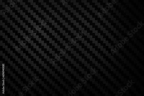 Carbon fiber composite raw material background. Carbon fiber texture. Dark Gray background with lighting. photo