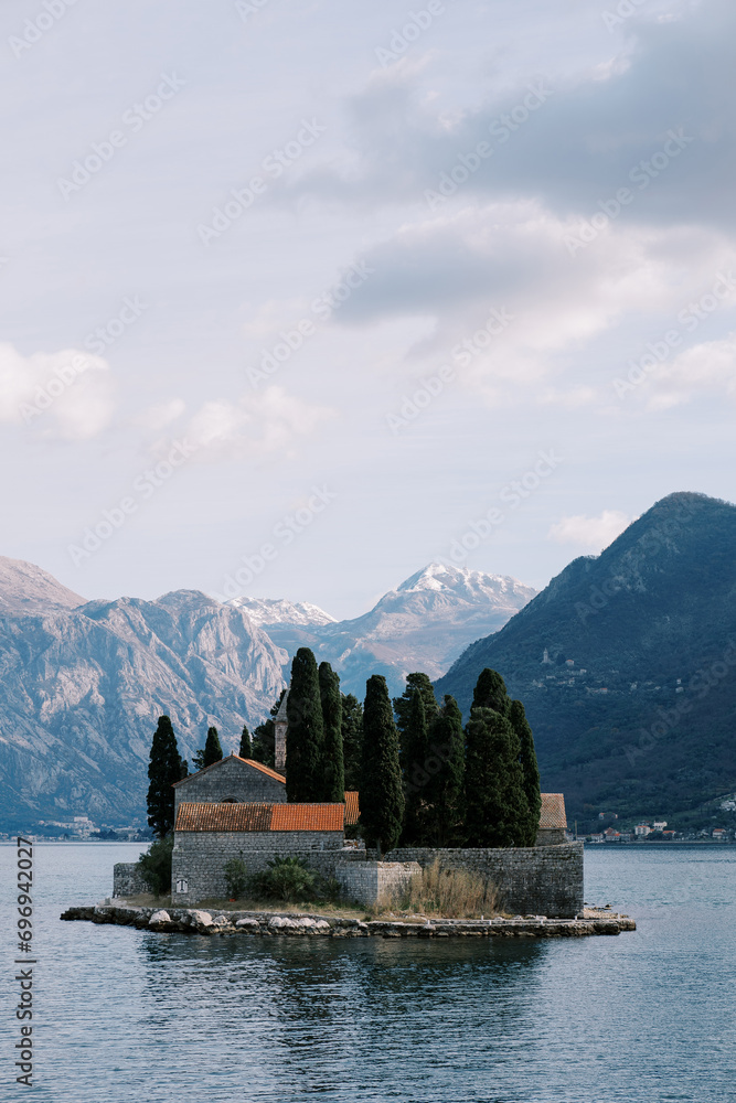Island of St. George in the Bay of Kotor against the backdrop of mountains in the haze. Montenegro